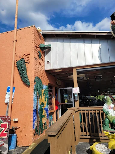 Gatorz entrance with hand-painted gator mosaic on the brick wall