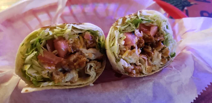 Chicken wrap cut in half on parchment
