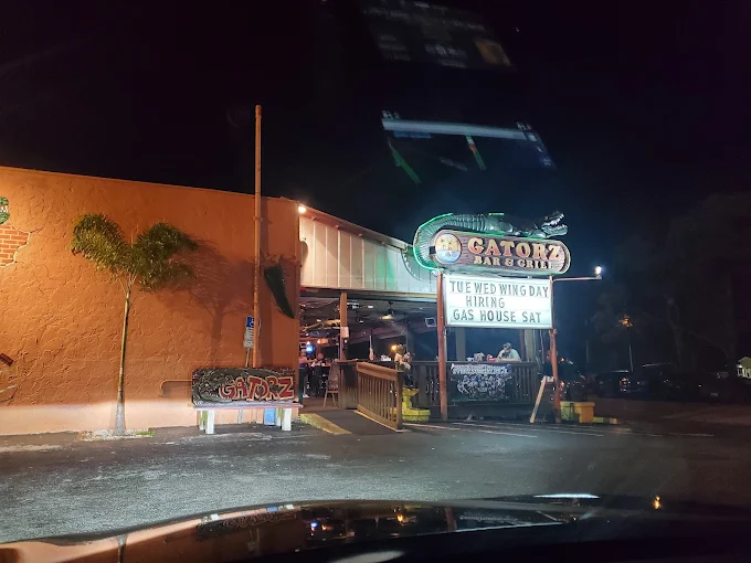 Gatorz at night with the lit-up sign and event board