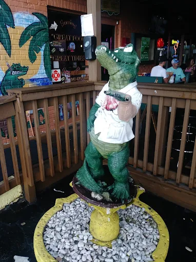 Iconic green gator statue inside Gatorz Bar & Grill