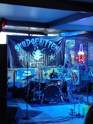 Live band on stage at Gatorz under blue stage lights