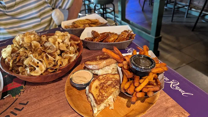Grilled reuben with sweet potato fries and wings at Gatorz