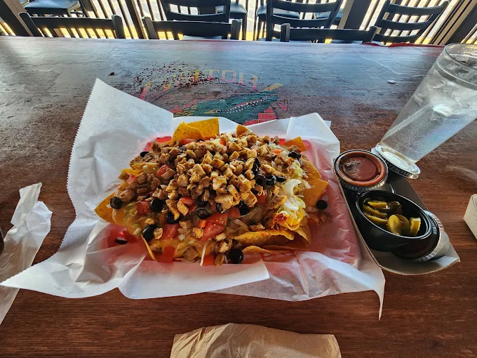Loaded chicken nachos on the table at Gatorz